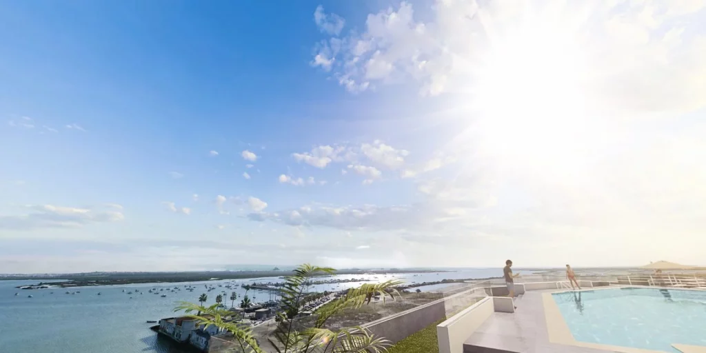 Vista panorámica desde la terraza y piscina de una promoción de obra nueva junto al Parque Natural de la Bahía de Cádiz, con vistas al mar y al entorno natural.